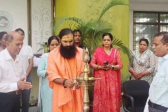 Swami Dheerendraacharya leading a yoga session with teachers and students at CUJ.
