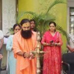 Swami Dheerendraacharya leading a yoga session with teachers and students at CUJ.