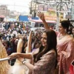 Hema Malini and Esha Deol waving to fans during the showroom inauguration in Ranchi.