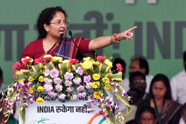 Kalpana Soren speaking at a Jharkhand election rally with a large gathering of supporters