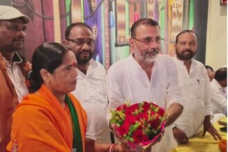 Nishikant Dubey speaking at the Ghatwar community conference in Gandey, advocating for BJP candidate Munia Devi.