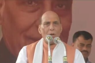 Rajnath Singh addressing a large crowd at the Lohardaga election rally, emphasizing the protection of tribal lands.