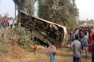 Overturned bus in Ramgarh with onlookers and emergency responders at the accident scene.