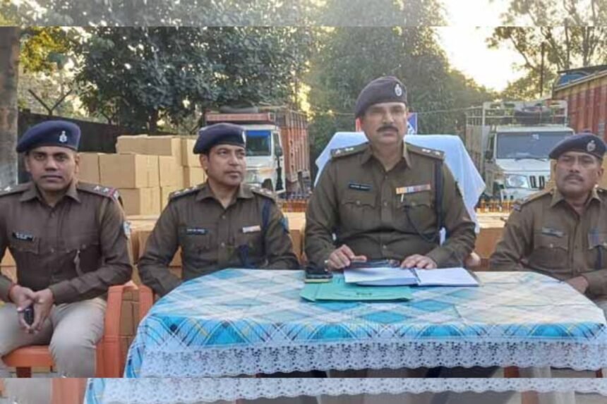 Massive seizure of illegal liquor by Koderma police with vehicles and cartons displayed, highlighting the successful operation against smuggling.