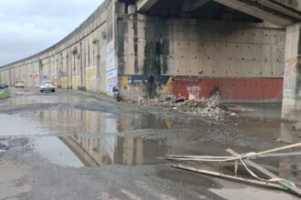 Garbage piles and stagnant water at Tupudana Nepalese Colony entrance in Ranchi