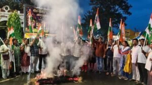 Congress workers burn an effigy of Prime Minister Narendra Modi during a protest in Chaibasa
