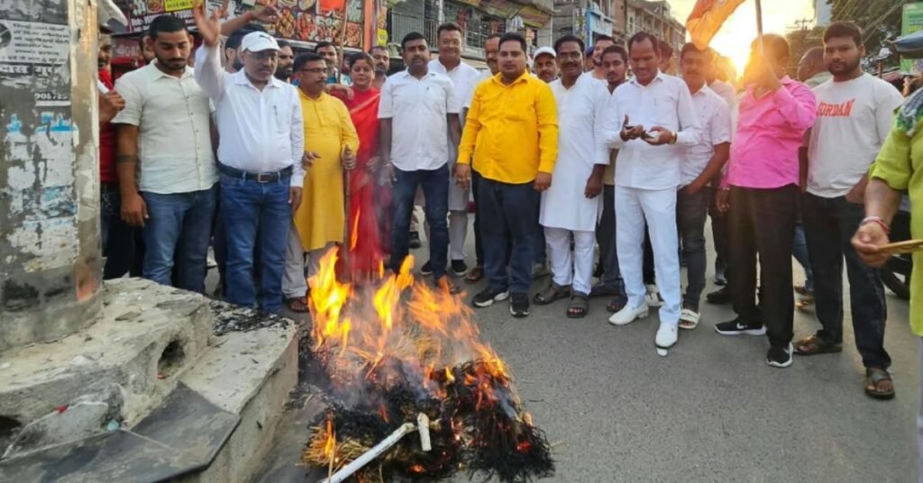 Protesters burn an effigy during a demonstration over an alleged paper leak at Tower Chowk in Giridih