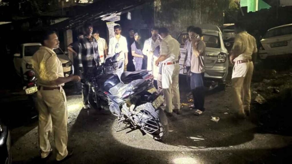 Police personnel check two men near a vehicle during a nighttime checking operation in Ranchi