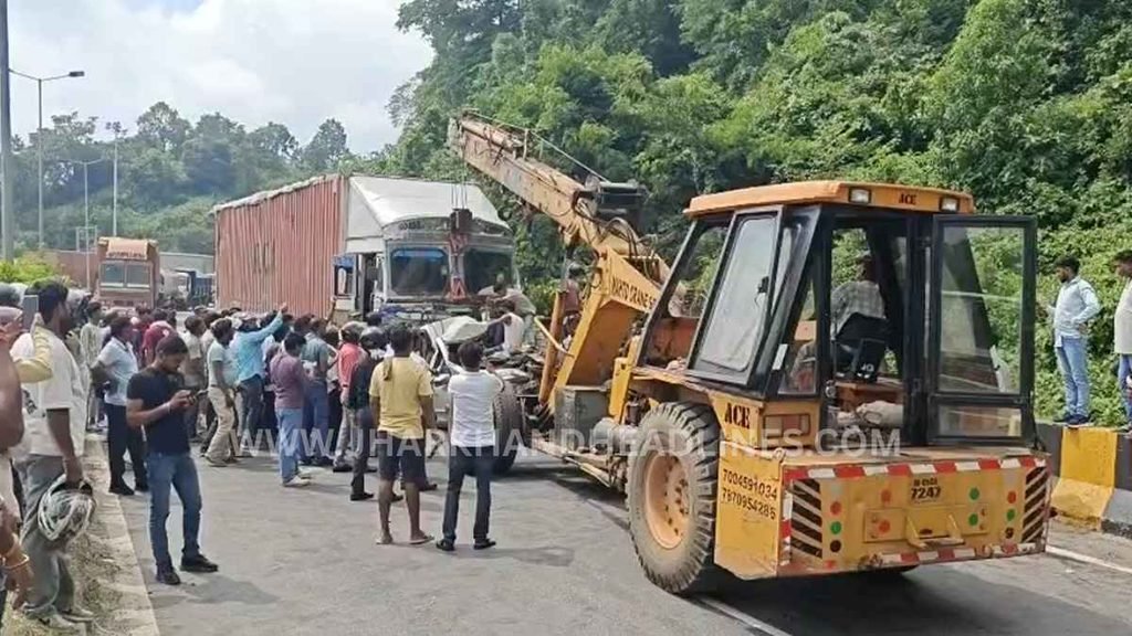 Rescue machinery clears a damaged vehicle from the road after an accident