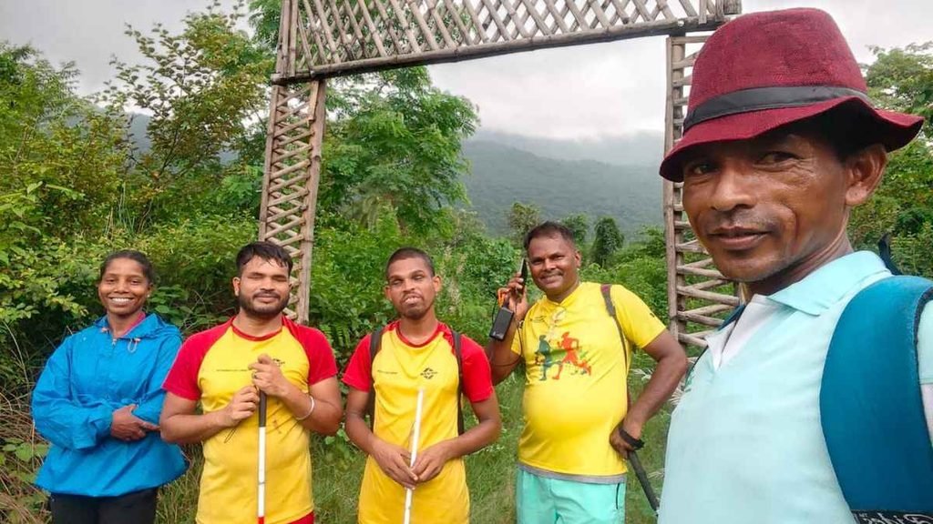Visually impaired climbers pose with their support team during a mountain expedition